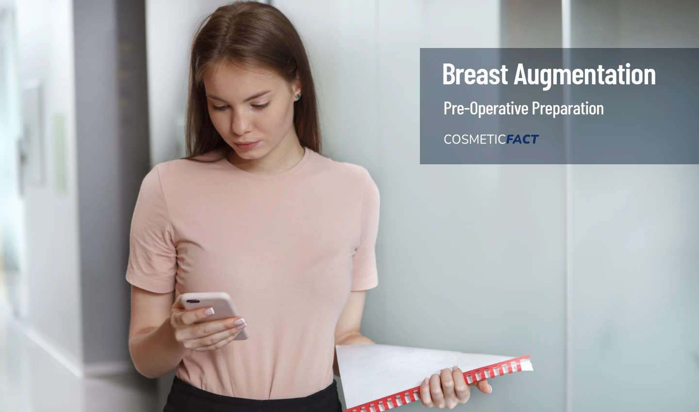 A woman holding a checklist in her hand, preparing for breast augmentation surgery.