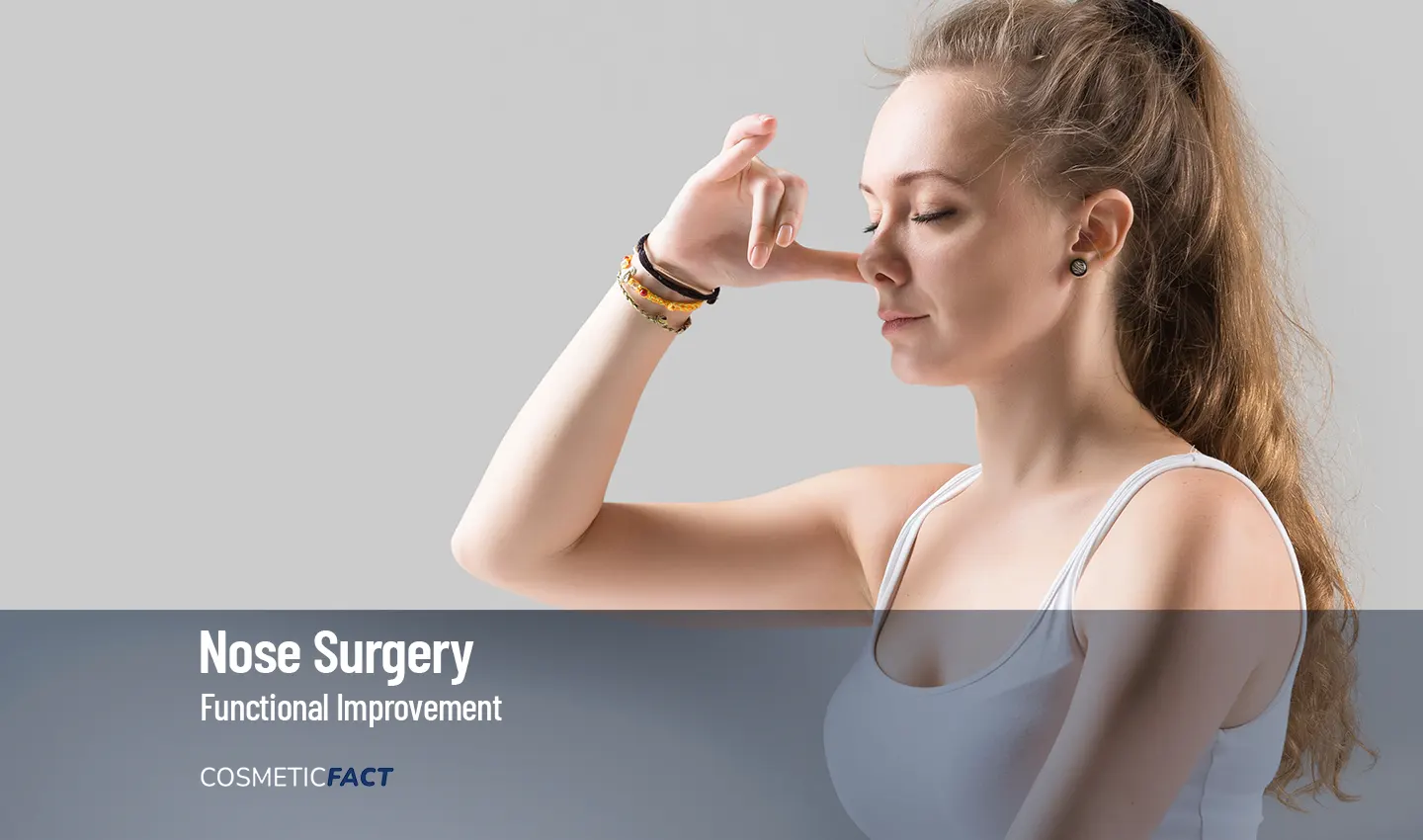 Woman touching her nose, representing the benefits of functional rhinoplasty for improving breathing function and alleviating sinus issues.