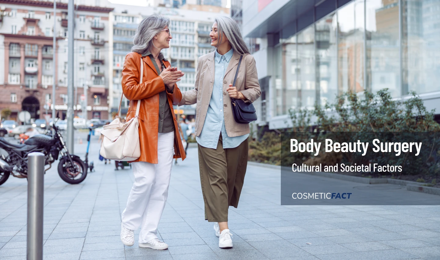 Two middle-aged women smile and talk on a street corner, representing the importance of navigating societal pressures and beauty standards related to body surgery.