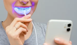 Woman receiving advanced oral care treatment with a smart toothbrush, demonstrating the benefits of cutting-edge dental technology.