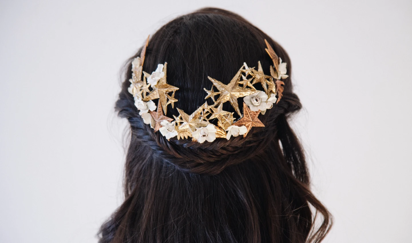 "A woman's hair styled with glamorous hair accessories, including sparkling clips and headbands, perfect for adding shine to any party look
