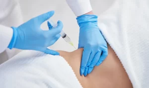 A doctor administering a non-invasive body surgery alternative injection to a patient.