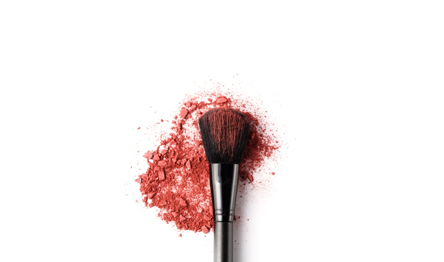 A makeup brush covered in blush, highlighting the artistry and beauty of makeup brushes.