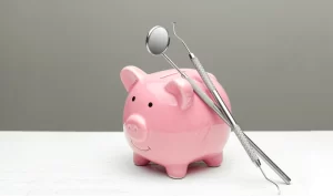 Dental tools for affordable teeth surgery next to a pig, representing cost-saving options.