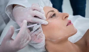 Woman receiving a natural facelift through the injection of dermal fillers