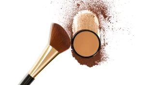 "Image of a bronze blush and brush, representing the importance of choosing the right bronzer for your skin tone."