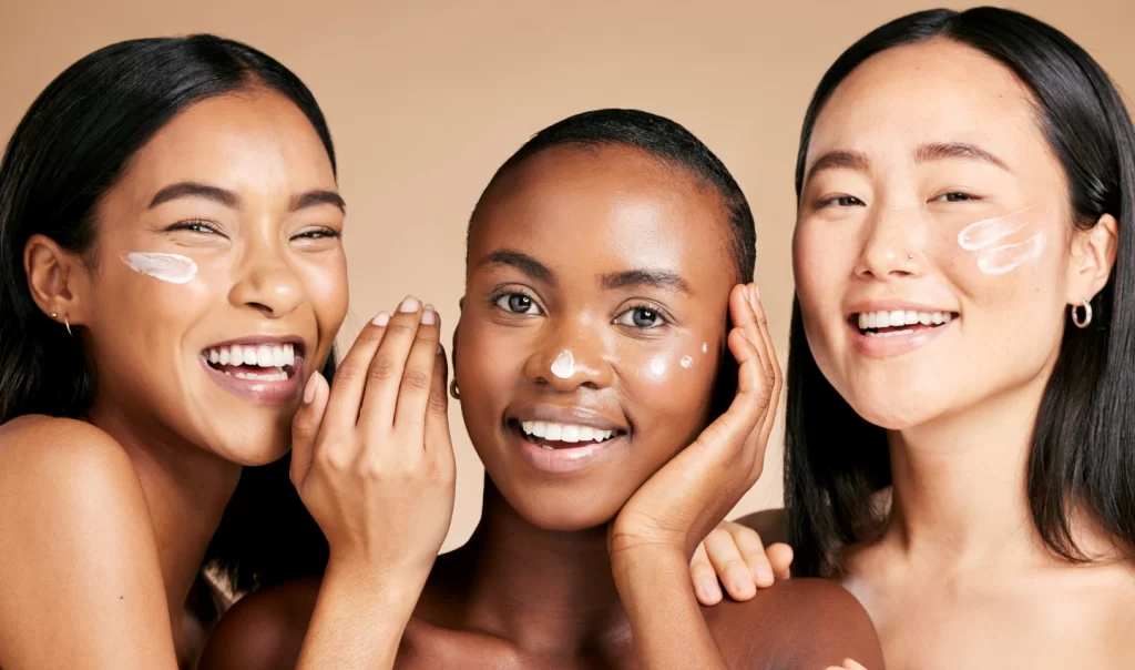 Happy women with lotion on their faces, enjoying the benefits of chemical peels and revealing radiant skin