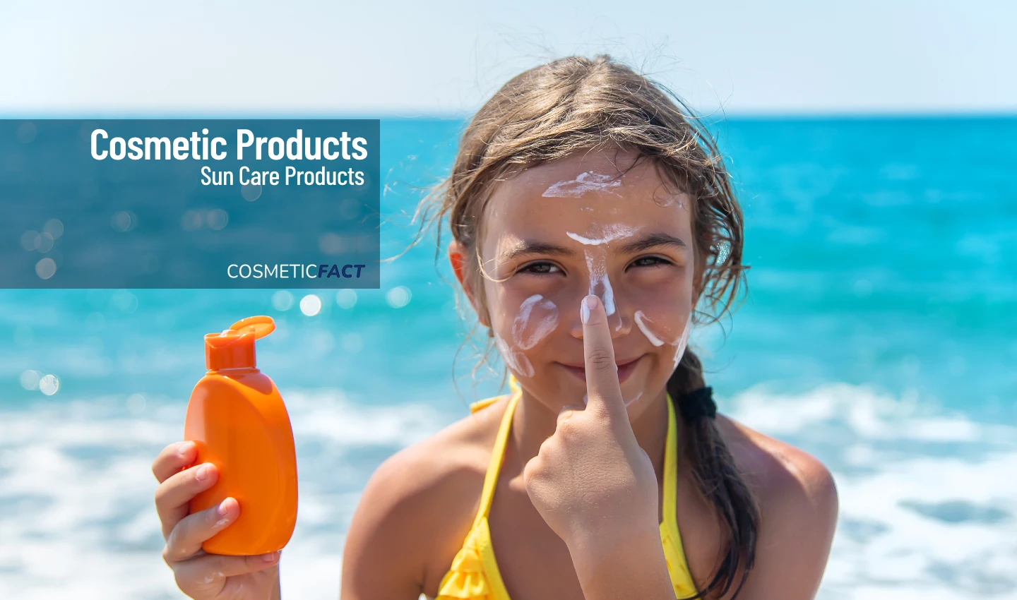 A child applying adventure-proof sunscreen to her nose, grinning happily.