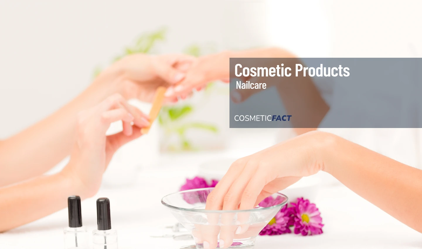 A woman's hand receives a natural nail treatment during a manicure session, surrounded by various natural nail products.