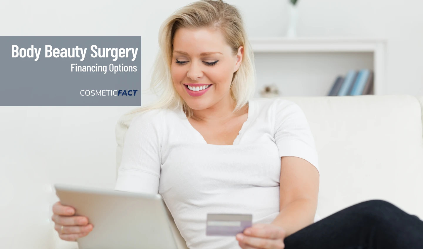 A woman smiles as she holds a bill for body beauty surgery and looks at her credit card.