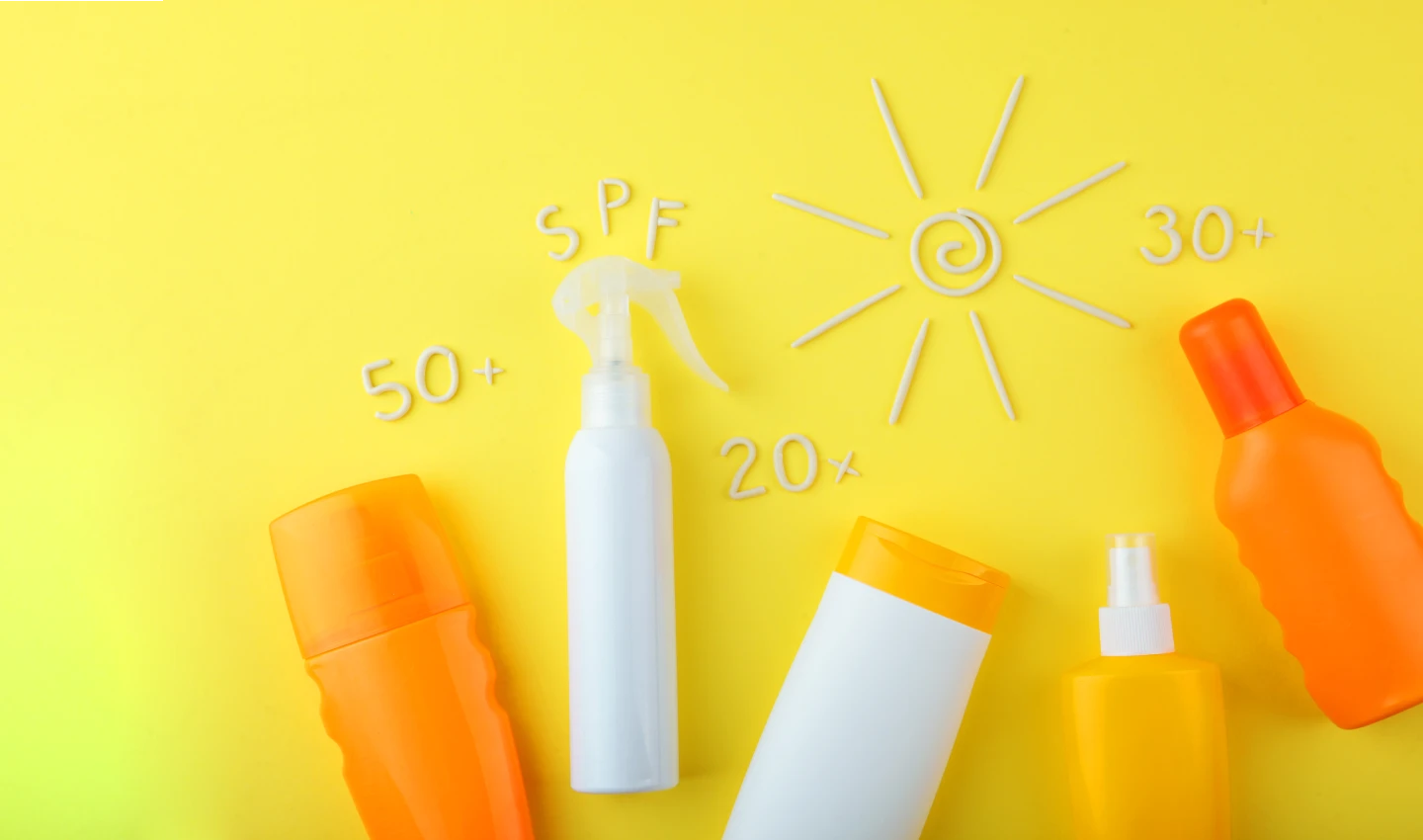 A group of different types of sunscreen displayed together, including lotions, sprays, and sticks, showcasing a range of SPF options to debunk common sunscreen myths.
