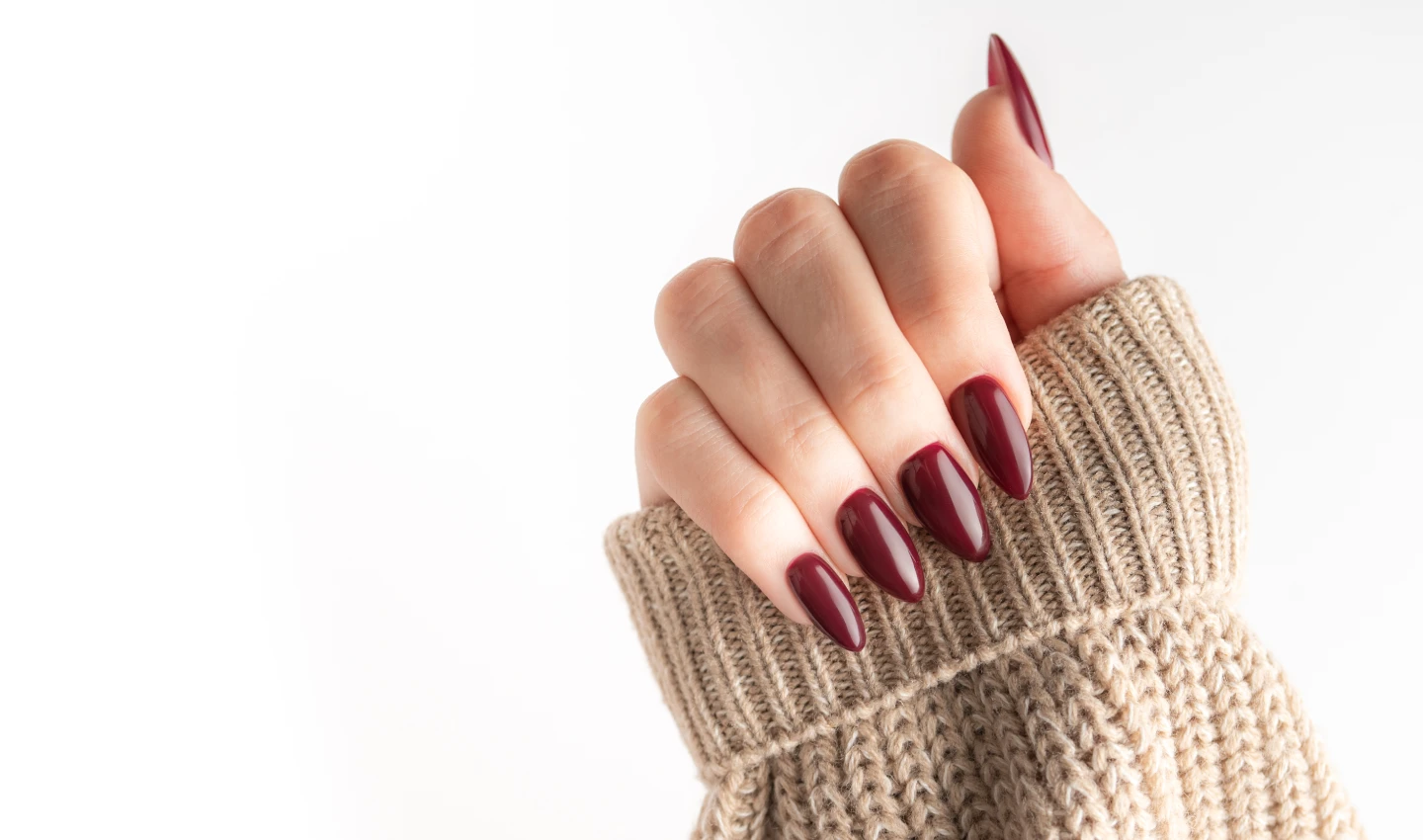 A close-up image of a hand with perfectly polished nails using nail extensions, highlighting the world of glamorous nail transformations.
