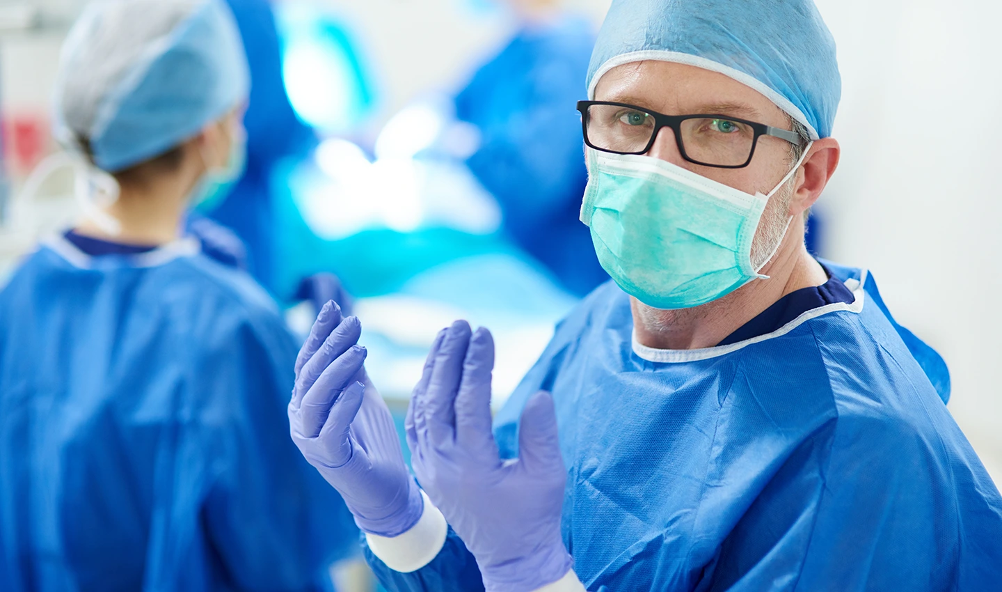 A doctor with Rhinoplasty Board Certification prepares for surgery.
