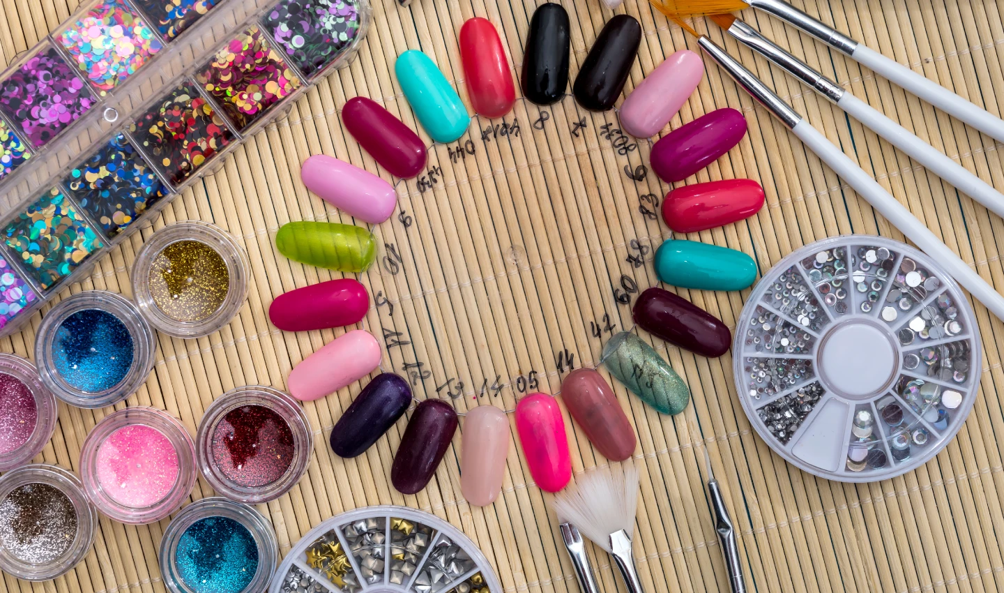 Image of different coloured nails with intricate designs created using trendy nail art accessories like brushes, stencils, gems, stickers, and marbling tools.