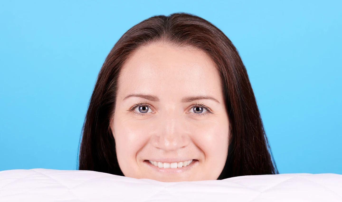 Before and after image of a young brunette girl smiling to the camera with teeth after undergoing affordable cosmetic dentistry, as described in our article on 0% financing for affordable cosmetic dentistry.