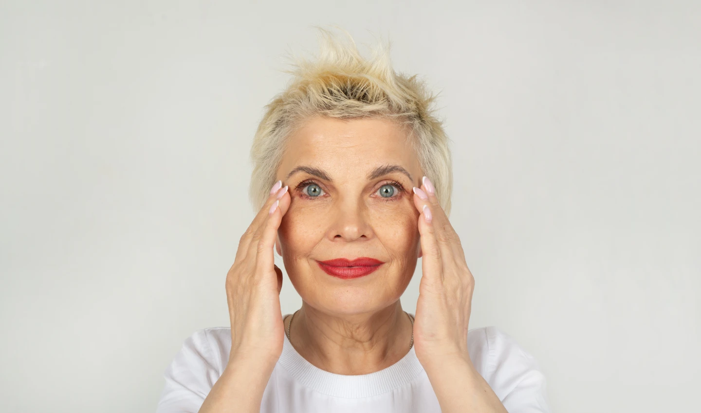 Middle-aged woman with fresh-faced look, demonstrating the power of eye serums for youthful-looking eyes.