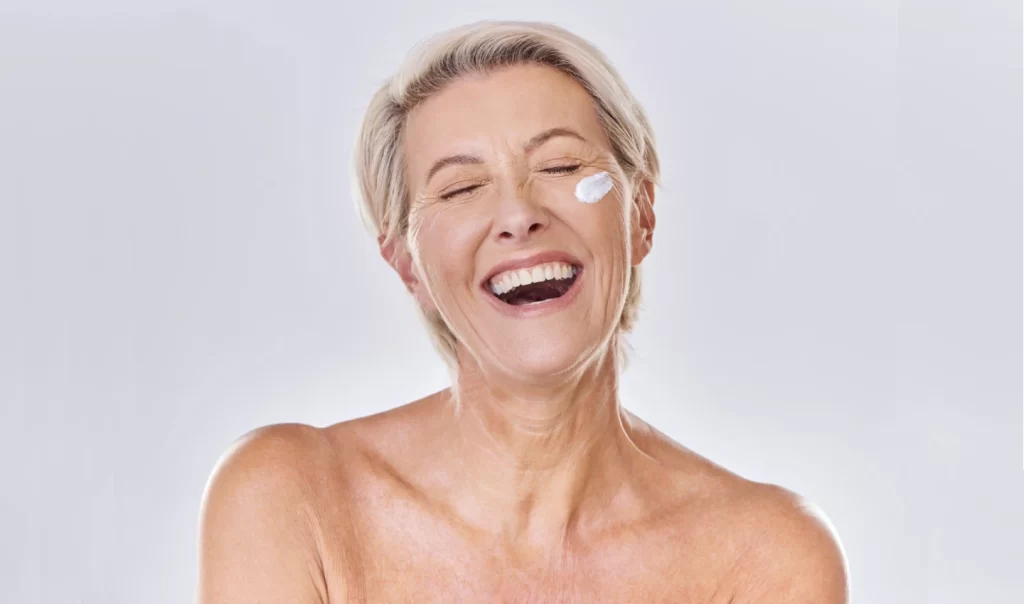 Mature lady with radiant skin, looking satisfied after using Retinol Skincare products.