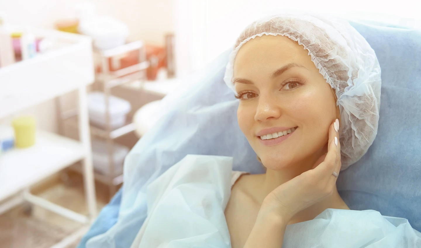 A woman in a hospital gown prepares for hairline restoration surgery by following the essential pre-operative steps of hairline restoration preparation.