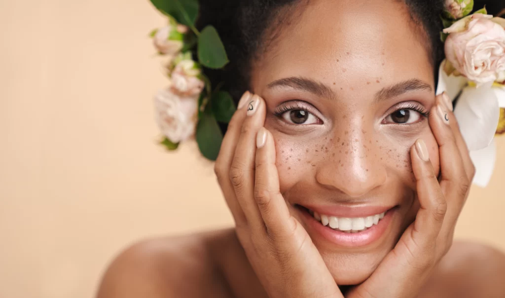 Woman smiling and showing her radiant, glowing skin after undergoing microdermabrasion treatment, demonstrating the magic of microdermabrasion.