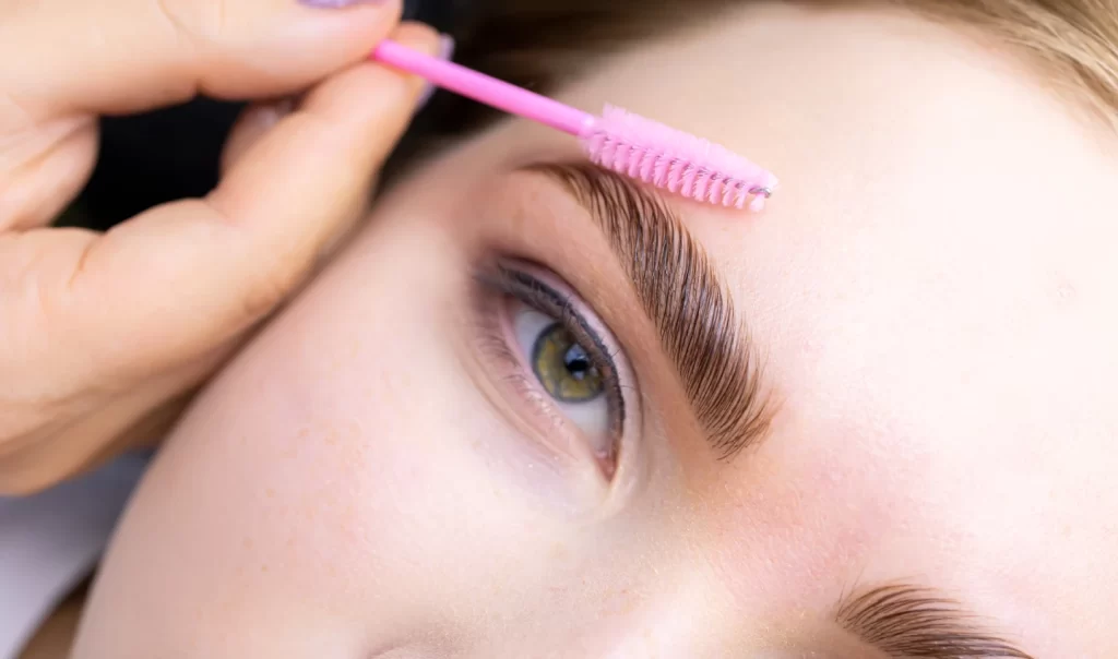 Well-groomed brown eyebrows of a young lady with green eyes, showcasing the importance of finding the perfect eyebrow pencil for your skin tone.