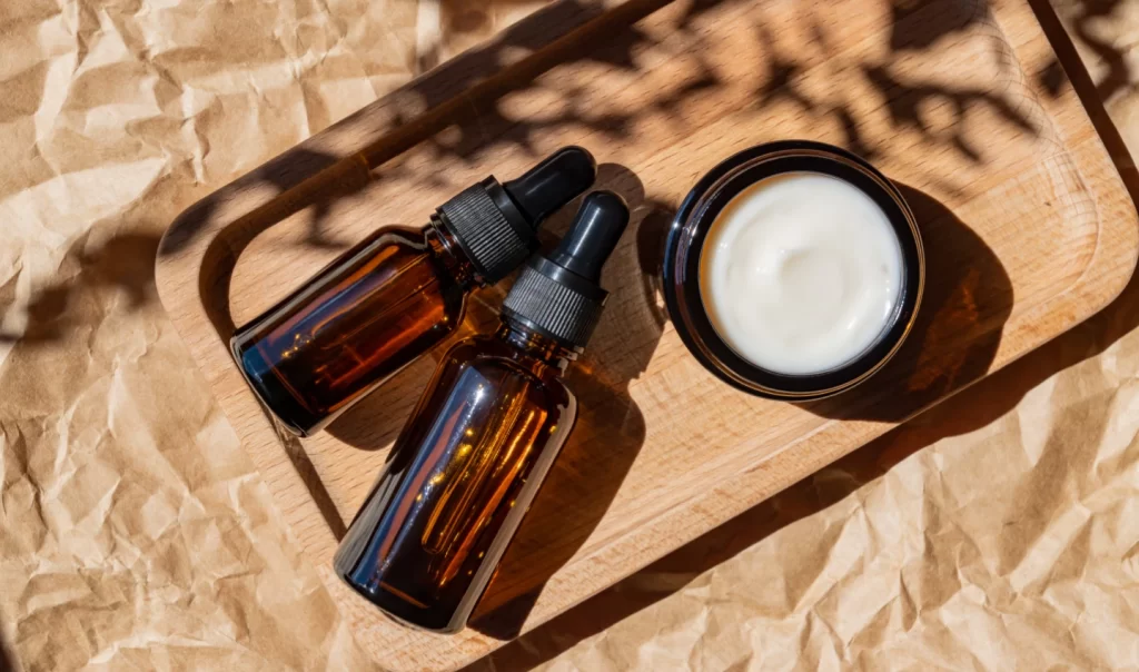Close-up shot of moisturiser and serum bottles showcasing the comparison between moisturisers and serums for skincare.