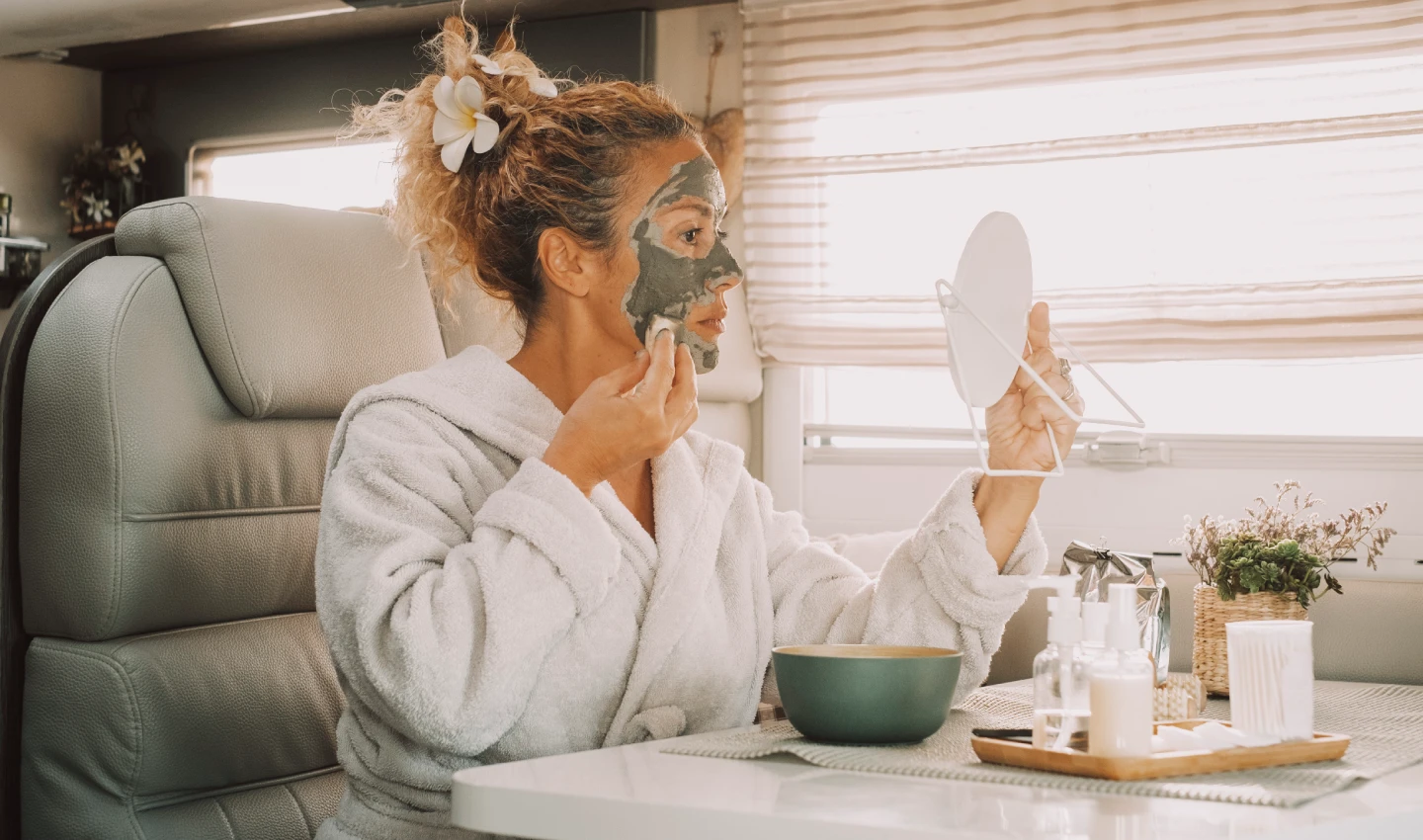 Woman applying DIY scrub made with natural ingredients like sugar and coconut oil to her face, a great way to achieve glowing skin at home.