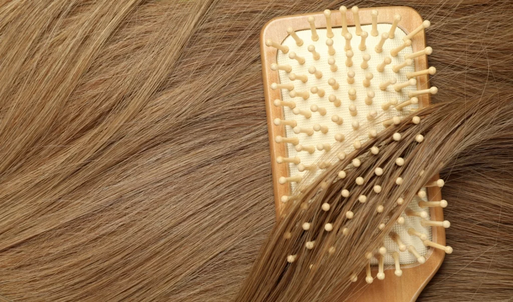 Keratin treatment before-and-after photo showing frizzy hair on the left and smooth, shiny hair on the right, with a comb alongside for styling.