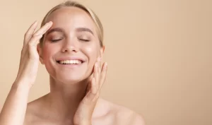 Woman smiling, showing her face after undergoing LED light therapy treatment, demonstrating the benefits of this non-invasive skincare treatment.