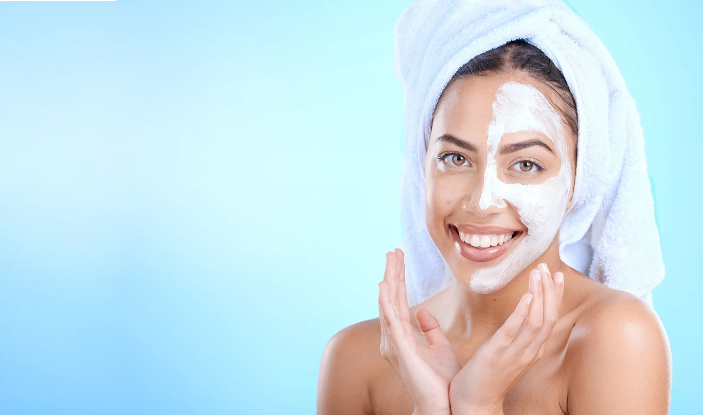 A young lady with a double scrub on her face, demonstrating the importance of double cleansing for clear and healthy skin.