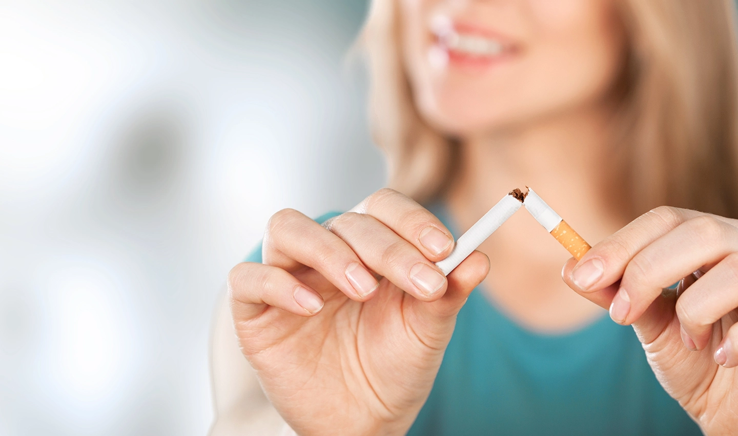 Black woman visiting surgeon for facelift and nose surgery, emphasizing the importance of quitting smoking before undergoing any cosmetic procedure.