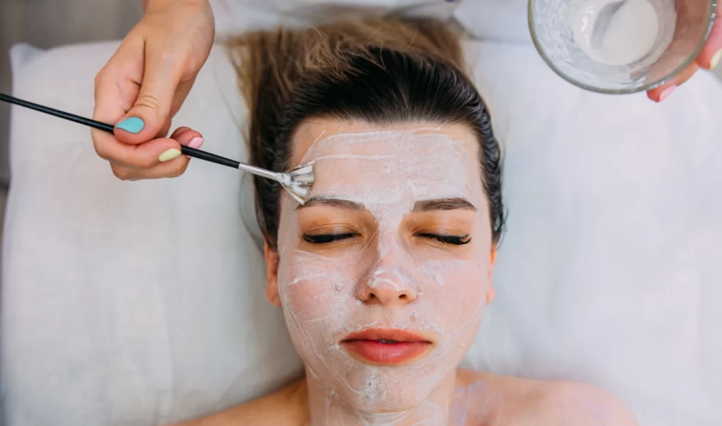 Woman undergoing Glycolic Acid Treatment on her face with noticeable improvement in skin texture and radiance.