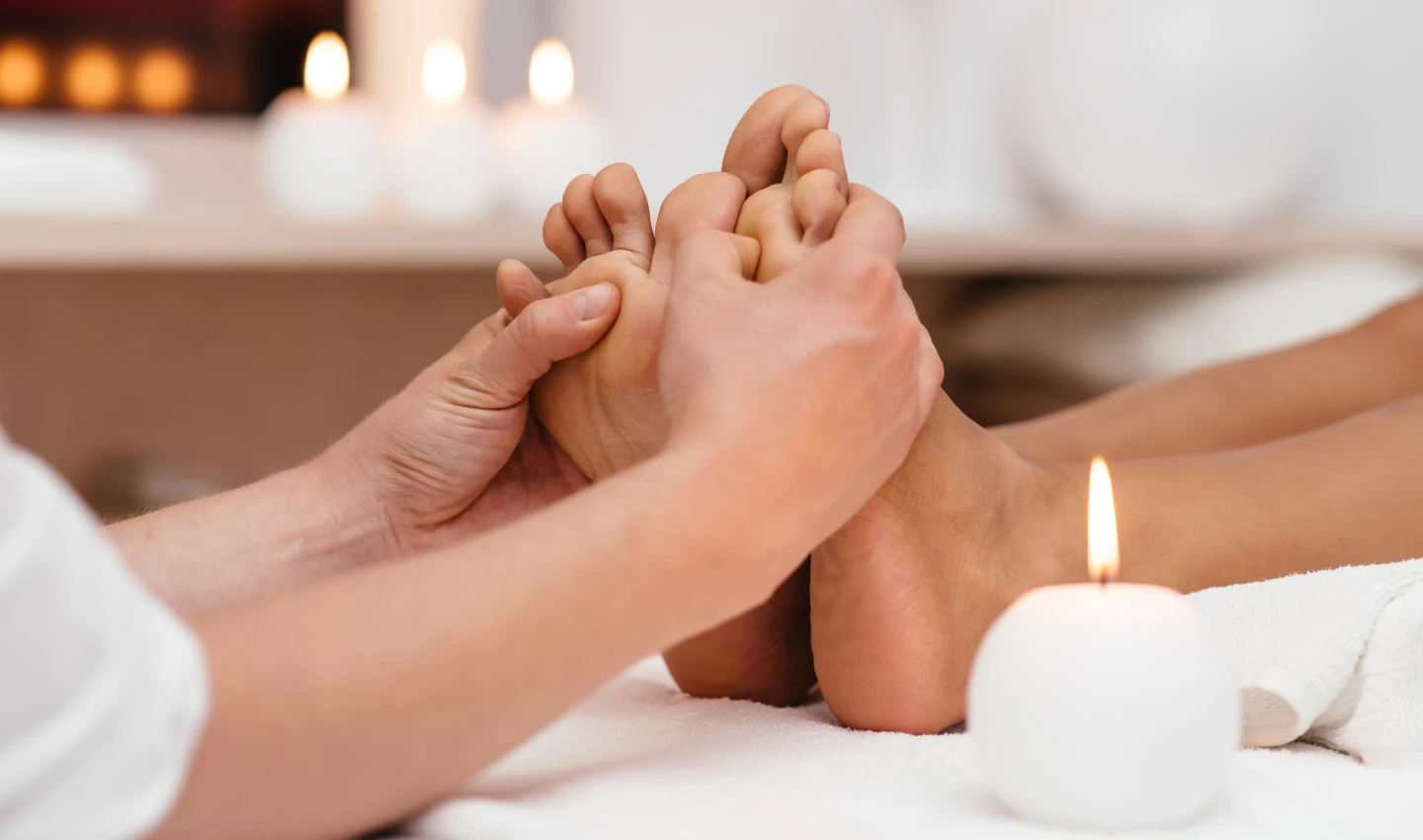 : Image of a person receiving a foot massage as part of reflexology wellness therapy.