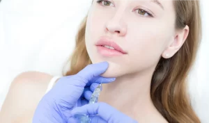 A girl getting ready for chin augmentation with dermal fillers, a non-surgical option for enhancing the size and shape of the chin to improve facial symmetry and balance.