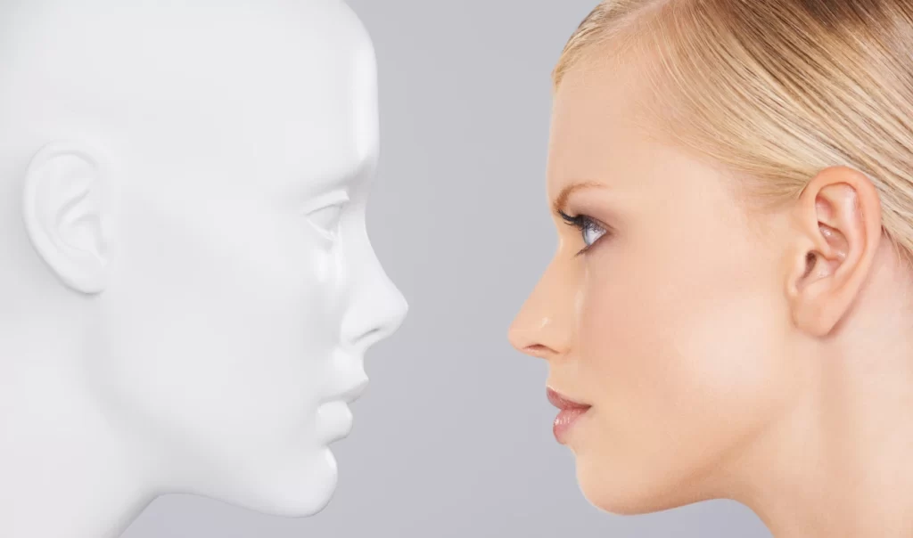 Image of a young and beautiful woman staring at an artifact that appears to be her own sculpture. The image represents the transformative power of Kybella's non-surgical facial sculpting in enhancing natural beauty and providing a more defined and balanced appearance.