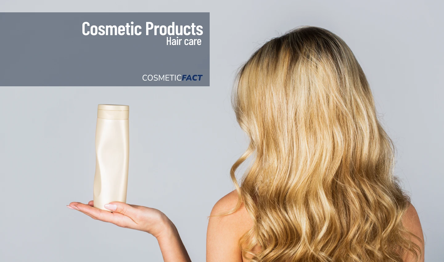 A woman holding a bottle of customizable hair conditioner, smiling with joy and excitement.