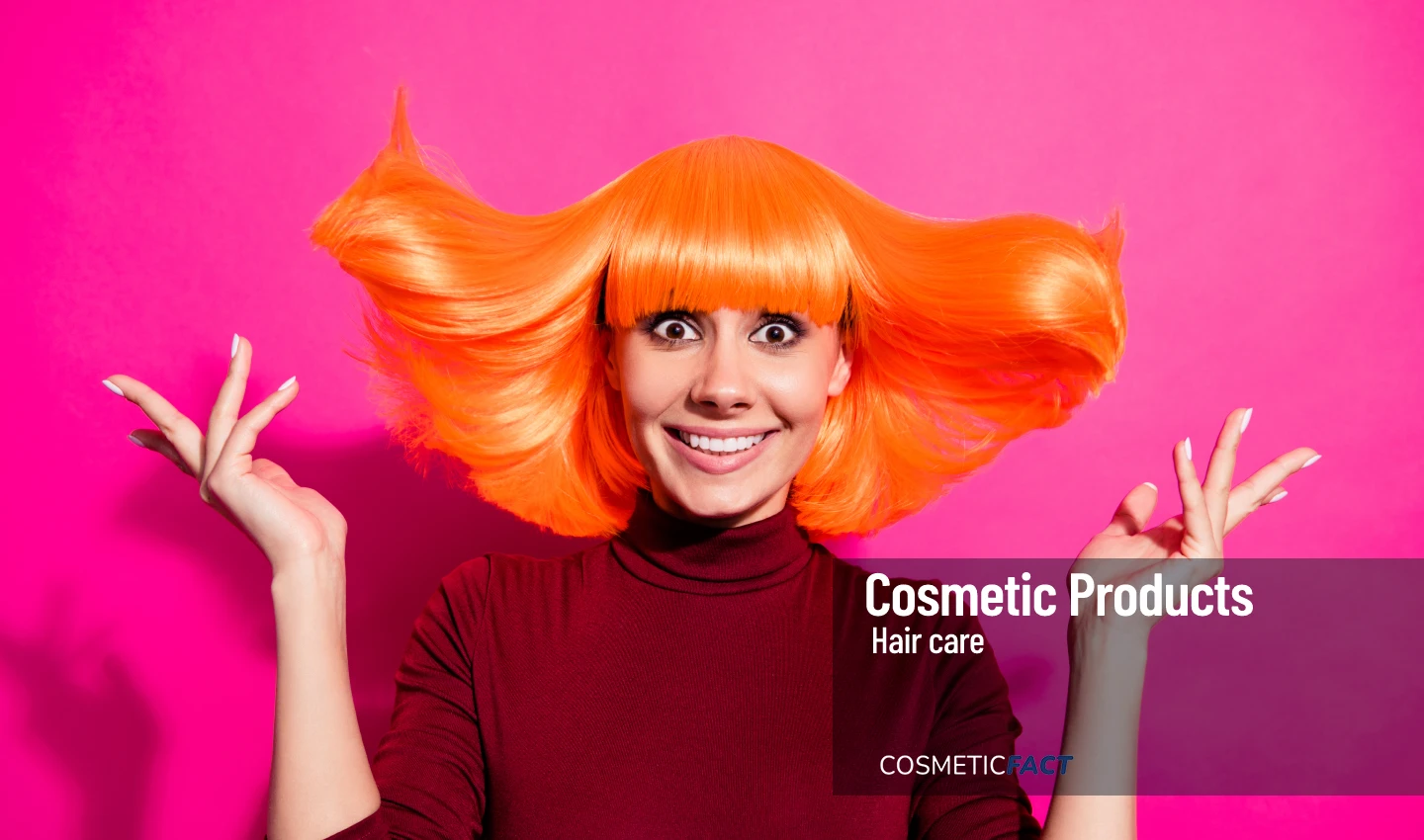 A woman with vibrant orange hair looks happy and confident, showcasing the transformative power of bold hair hues for a striking new look.