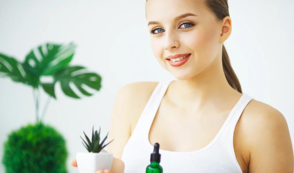 A close-up image of a woman's face with flawless skin, showcasing the benefits of using essences in a skincare routine.