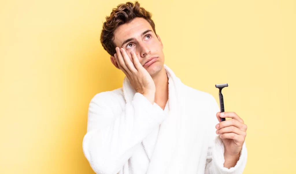 Close-up photo of a shaved man contemplating moisturizing after shave tips for soothing his skin.