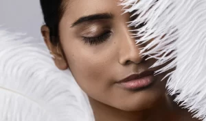 Woman with beautiful feathered eyebrow extensions showcasing the art of feathered eyelash extensions for effortless elegance.