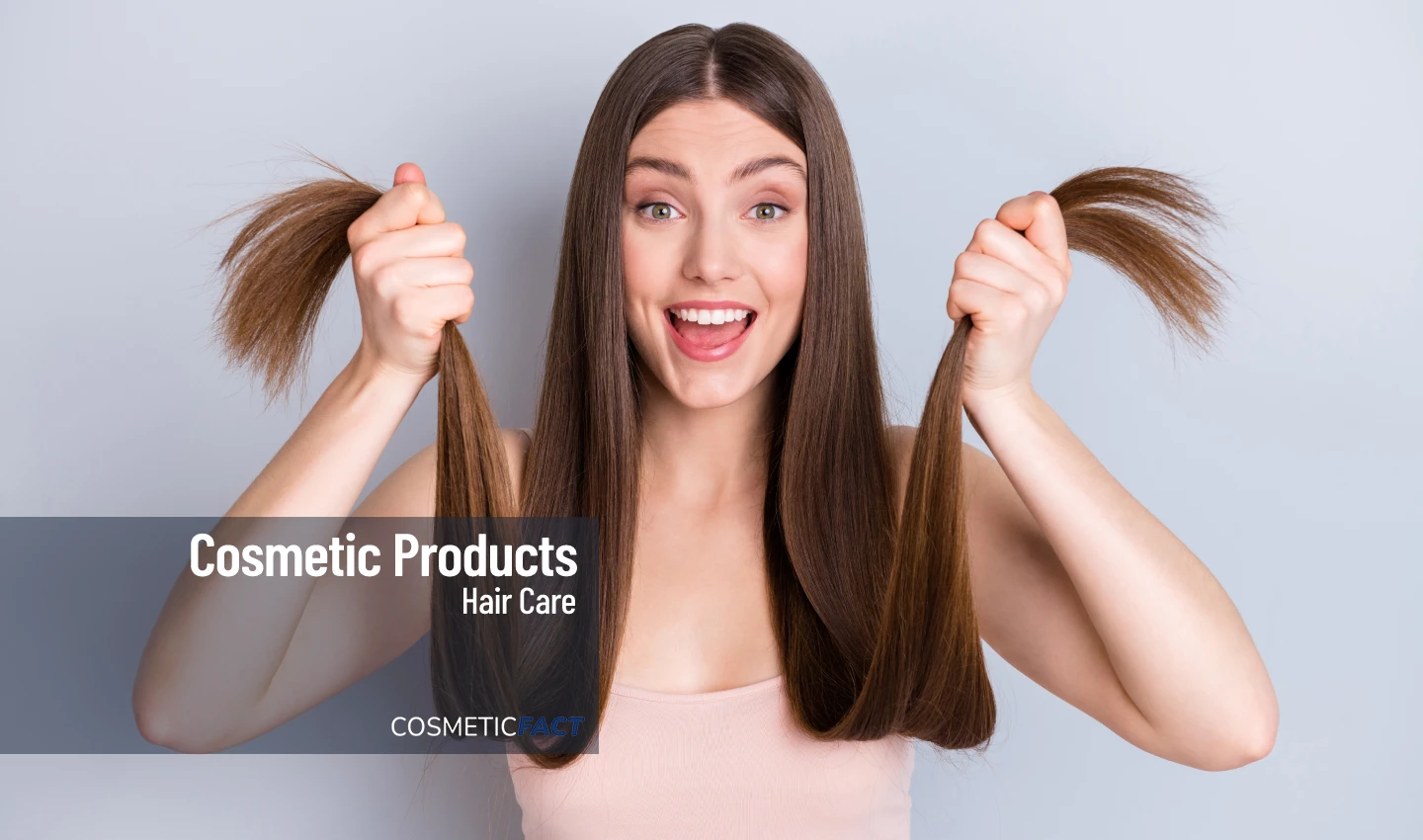 Young woman with extremely long and gorgeous hair laughing at the camera, showcasing the benefits of scalp therapy for promoting healthy hair growth.