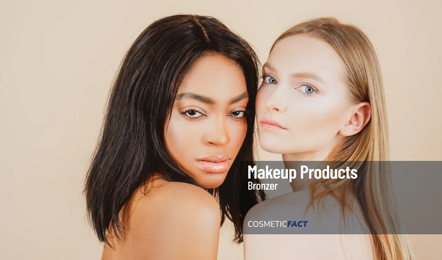 Two young women, one with bronzed skin and one with fair skin, looking at the camera seductively.