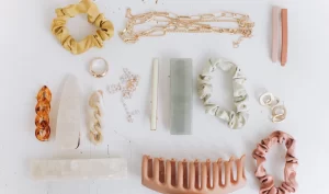 Flat lay view of a collection of fancy and beautiful hair accessories, including hair combs, hairpins, headbands, hair elastics, and hair clips, arranged in a stylish and elegant manner.