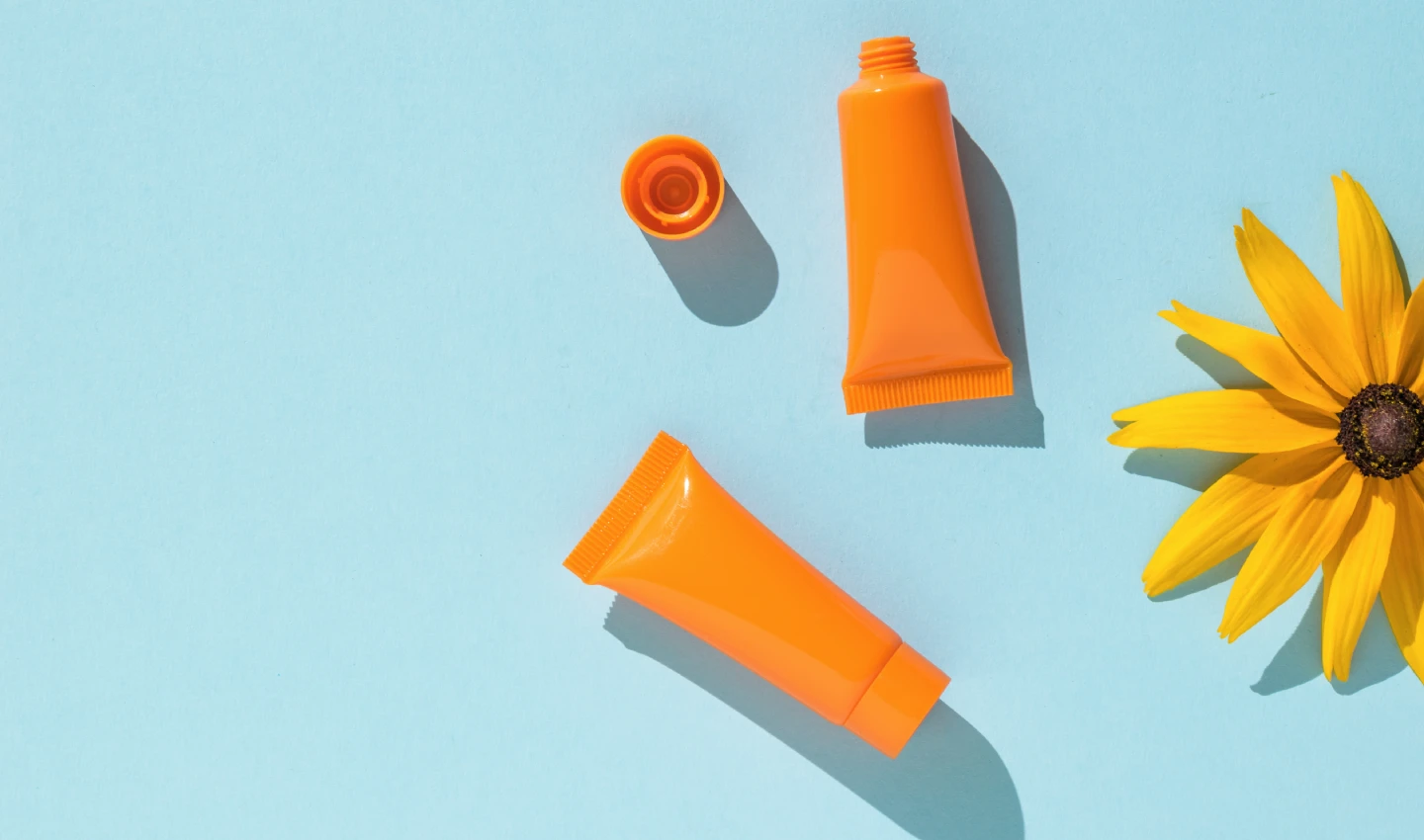 A photo of several sunscreen sticks in different colors and packaging, emphasizing their convenience and portability for on-the-go sun protection.