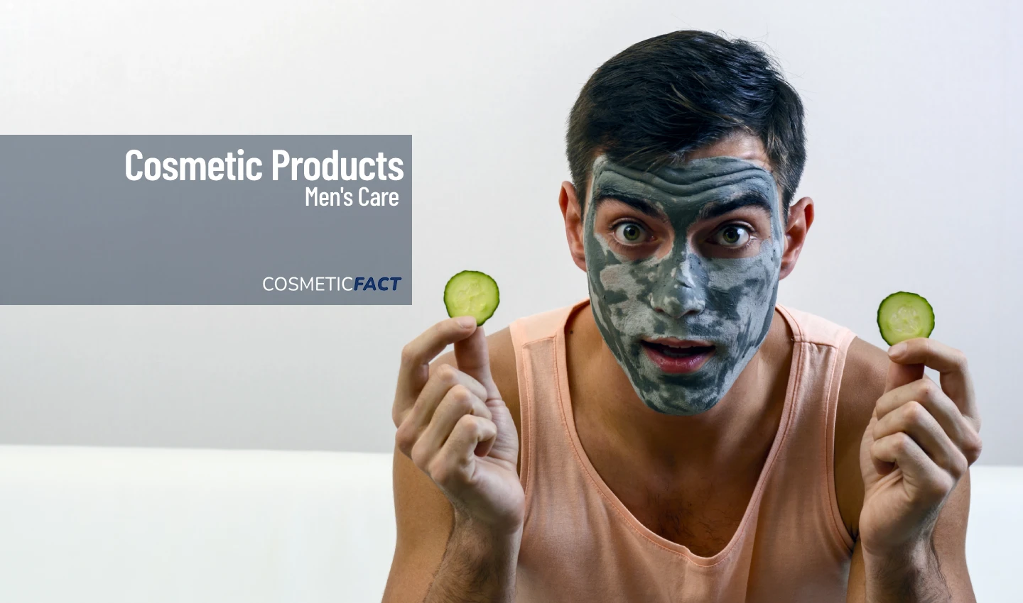 A man wearing a face mask and holding out a cucumber slice, representing a DIY face mask for men's skin care.