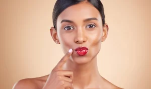 Woman showcasing her transfer-resistant lipstick for all-day beauty.