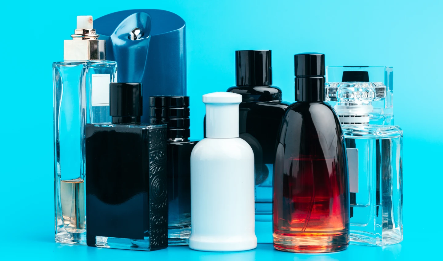 Men's Body Care Scents - An image of various bottles of perfumes and fragrances, showcasing the diversity of scents available for men's body care. From fresh and clean to musky and masculine, there's a scent for every personal style and preference. The image emphasizes the importance of finding the right fragrance to promote well-being and enhance your grooming routine.