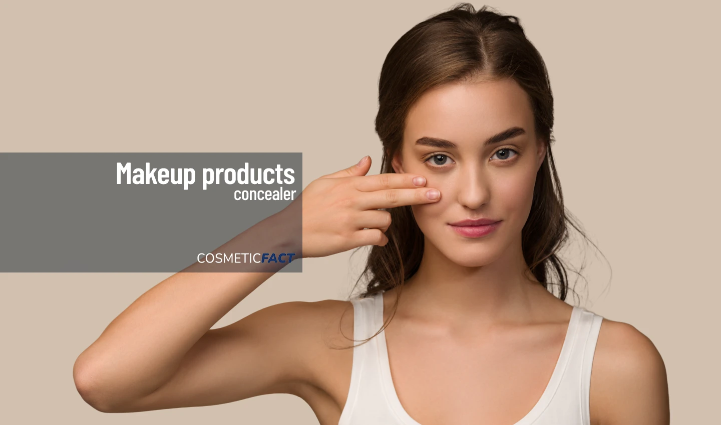 Woman applying under-eye concealer for a refreshed look.