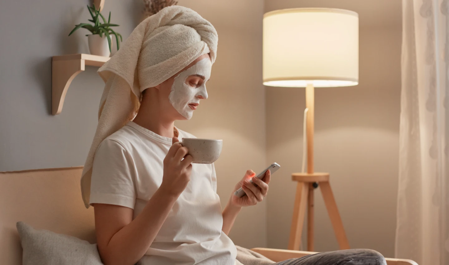 Woman applying night moisturiser cream to her face, promoting radiant skin through nighttime skincare.