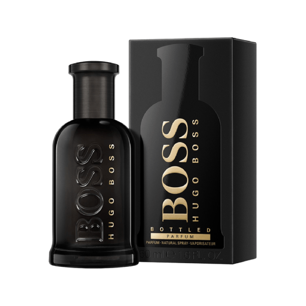 BOSS BOTTLED PARFUM fragrance bottle on a wooden surface with leaves in the background.