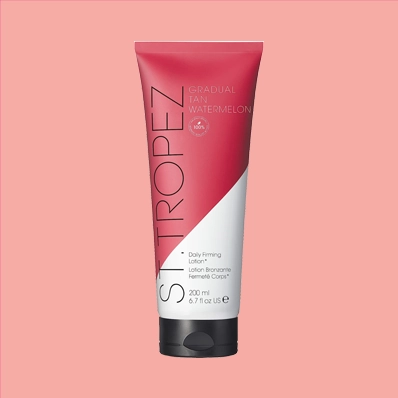 St.Tropez Gradual Tan Watermelon Lotion Tube - a skincare product that gradually builds a natural-looking, sun-kissed glow. The tube is pink and green with the product name and key ingredients. The lotion is visible through the tube.